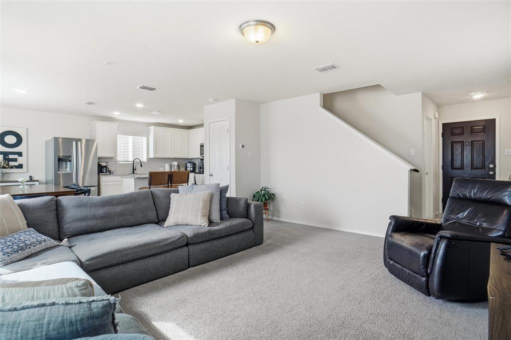 1719 Ackerly Drive Forney, TX 75126 - Photo 10 of 27 a living room with furniture and a flat screen tv