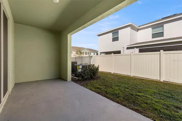 a view of a house with backyard and porch