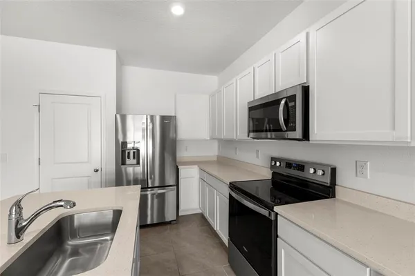 a kitchen with a refrigerator stove and microwave