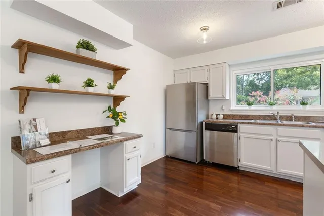 a kitchen with a refrigerator and a sink