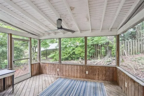 a view of a room with wooden floor and iron stairs