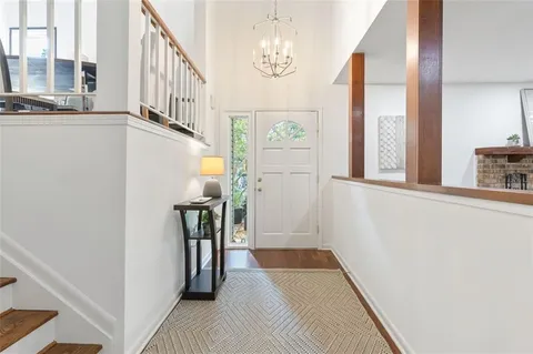 a view of a hallway with windows and stairs