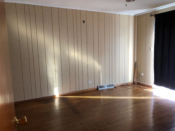 a view of a room with wooden floor