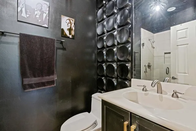a bathroom with a sink toilet and vanity