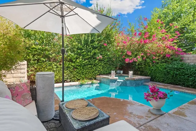 a view of a table and chairs under an umbrella