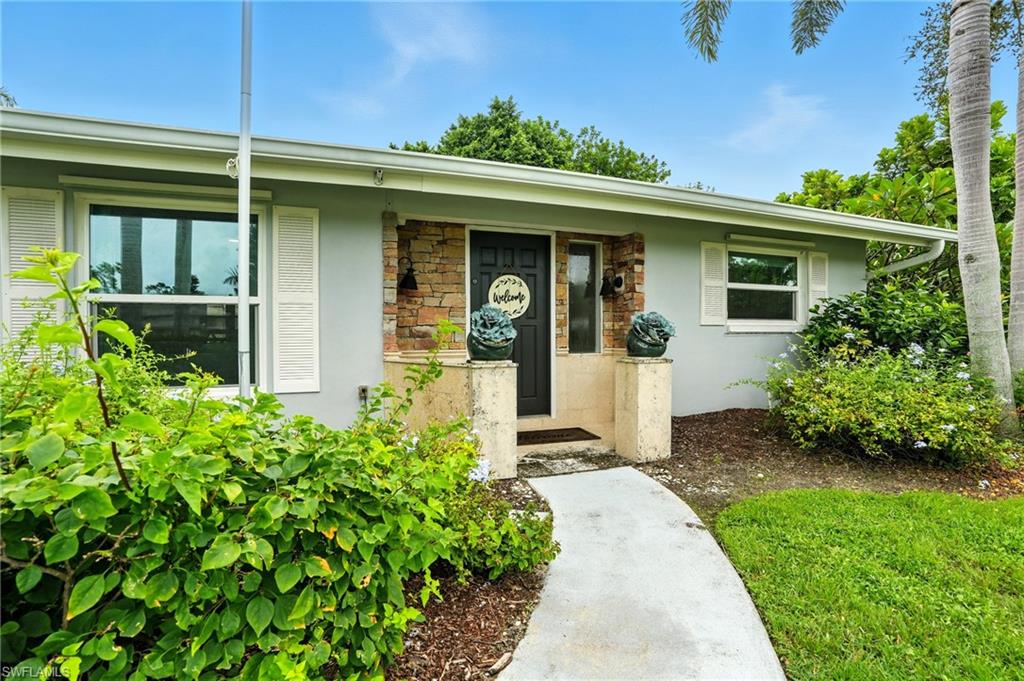 249 Pebble Beach Circle Naples, FL 34113 - Photo 5 of 45 Doorway to property featuring stone siding and stucco siding