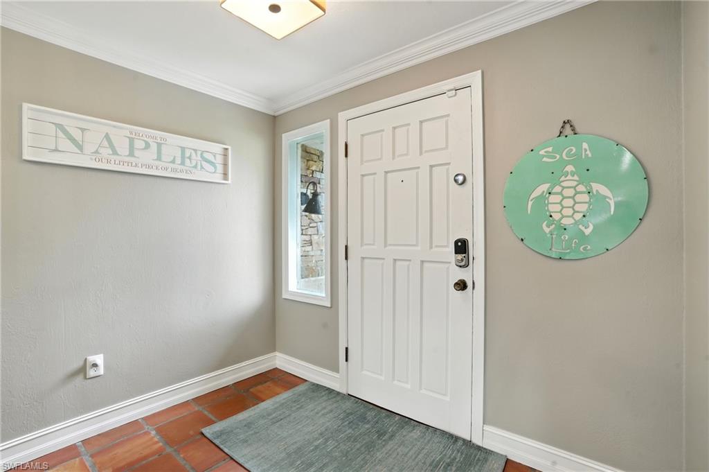 249 Pebble Beach Circle Naples, FL 34113 - Photo 7 of 45 Tiled entryway with baseboards and ornamental molding