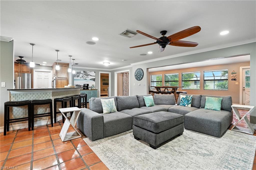 249 Pebble Beach Circle Naples, FL 34113 - Photo 8 of 45 Living area featuring ornamental molding, a ceiling fan, tile patterned flooring, and recessed lighting