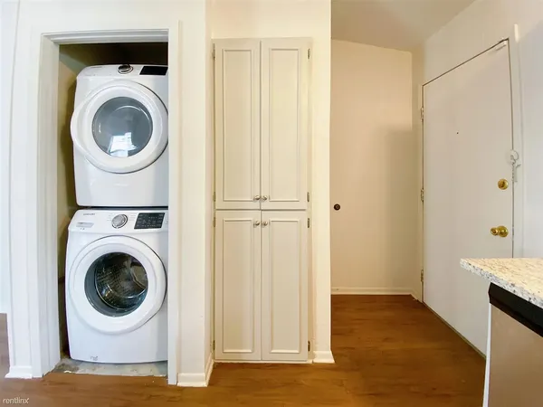 a view of a hallway with washer and dryer