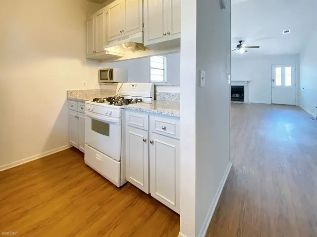 a kitchen with cabinets a sink and appliances