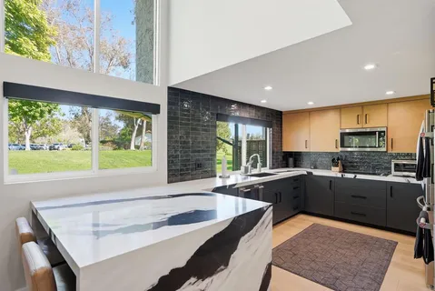 a kitchen with a stove a sink and a refrigerator