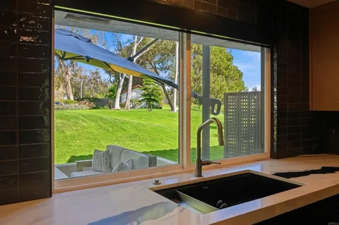 a view of a floor to ceiling window with wooden floor