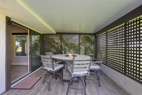a backyard of a house with table and chairs