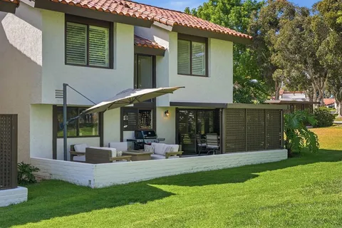 a front view of house with yard and outdoor seating