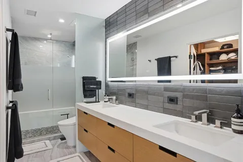a bathroom with a sink a toilet and shower