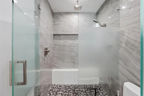 a bathroom with a bathtub and a shower