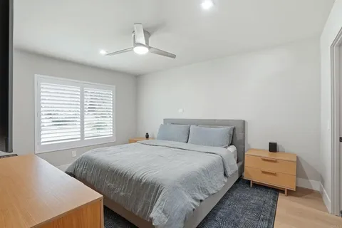 a bedroom with a bed and wooden floor