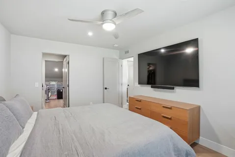 a bedroom with a bed and a flat screen tv