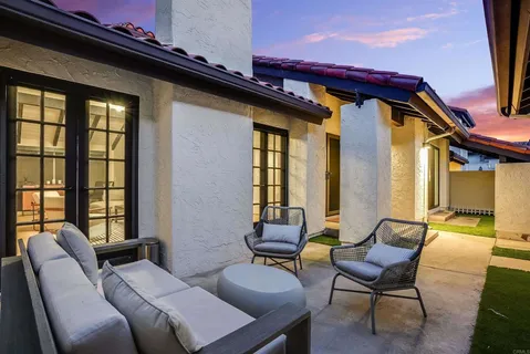 a view of a patio with a dining table and chairs