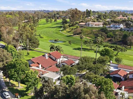 an aerial view of residential houses with outdoor space and river