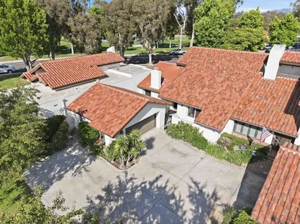 an aerial view of a house with garden space and street view