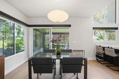 a view of a dining room with furniture window and outside view