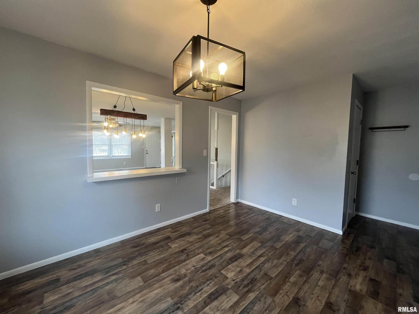 314 East 8th Street Metropolis, IL 62960 - Photo 12 of 33 a view of an empty room with wooden floor and a window
