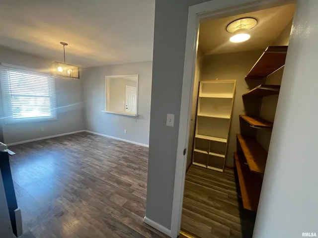 a view of an entryway with wooden floor