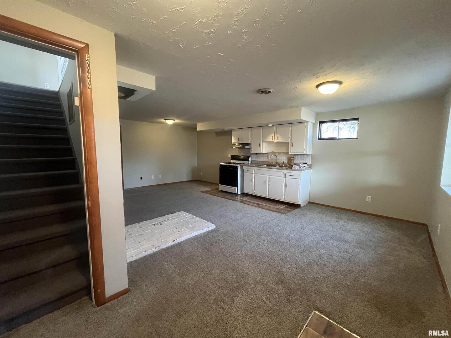 314 East 8th Street Metropolis, IL 62960 - Photo 21 of 33 a view of a livingroom with kitchen and staircase