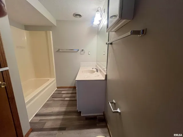 a bathroom with a sink a mirror and a shower