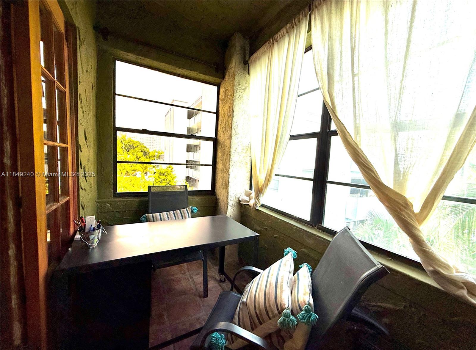 934 Michigan Avenue, Unit 304 Miami Beach, FL 33139 - Photo 14 of 30 a view of a workspace with furniture and a window