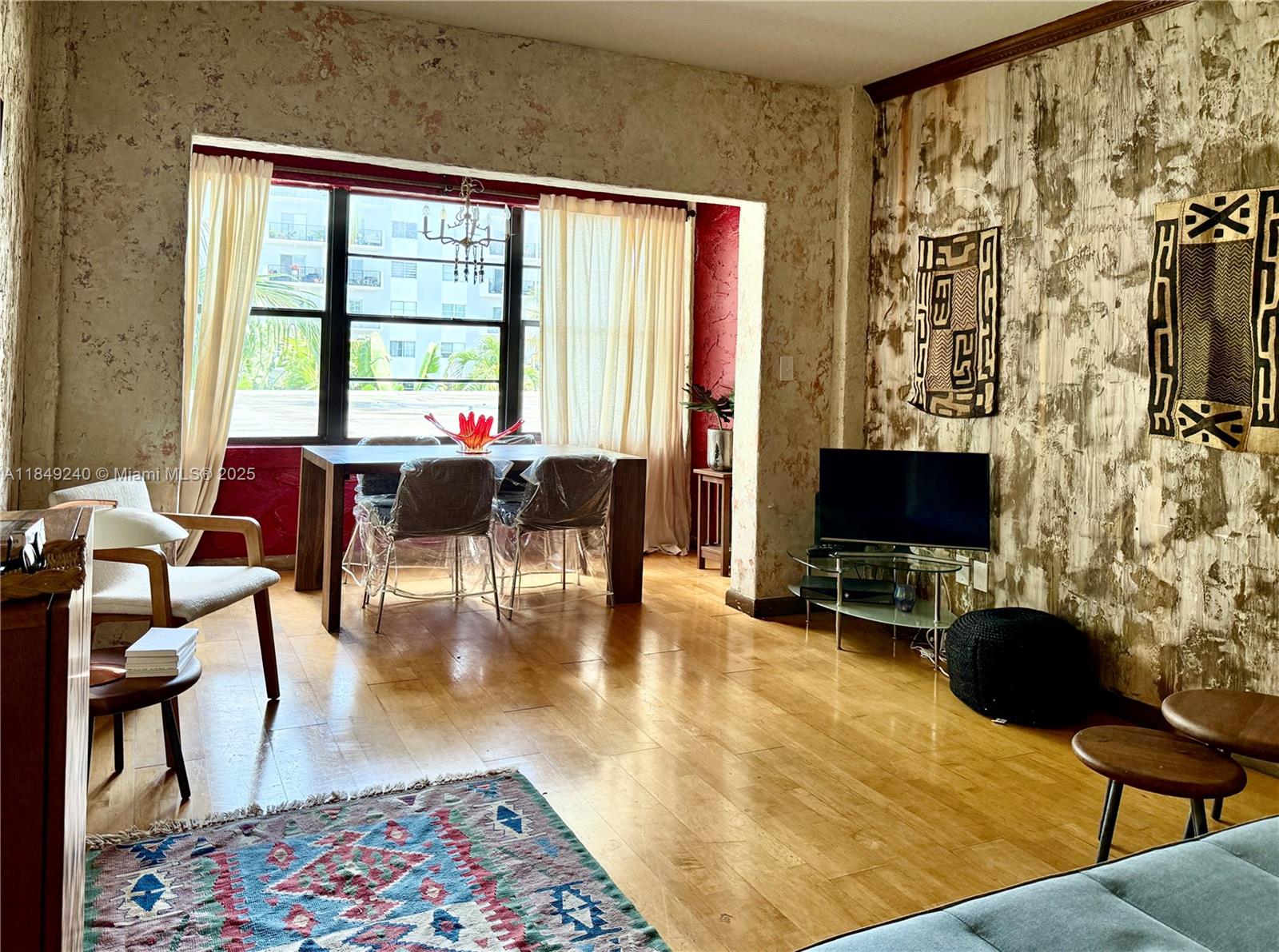 934 Michigan Avenue, Unit 304 Miami Beach, FL 33139 - Photo 2 of 30 a living room with furniture and a flat screen tv