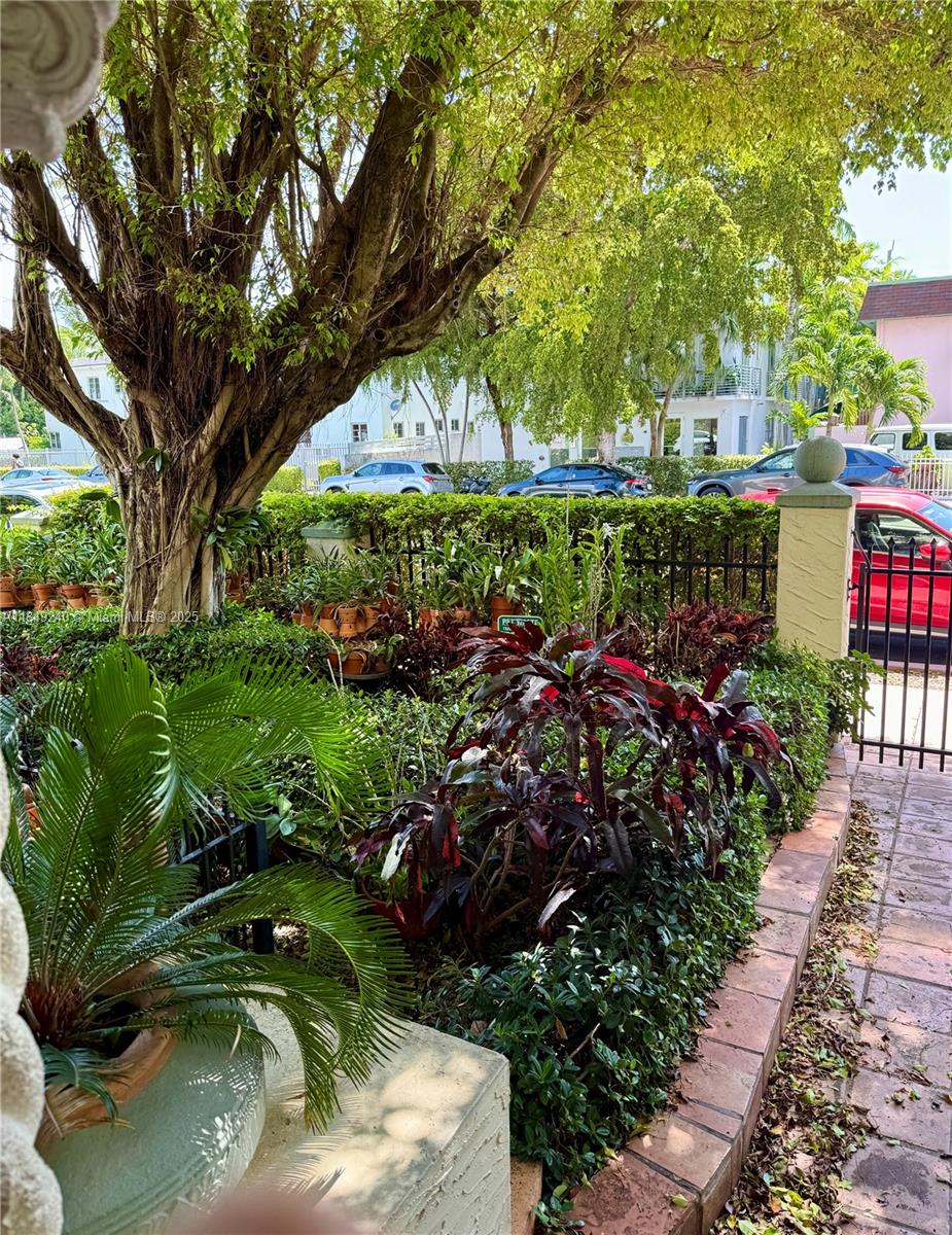 934 Michigan Avenue, Unit 304 Miami Beach, FL 33139 - Photo 23 of 30 a backyard of a house with a garden and outdoor seating