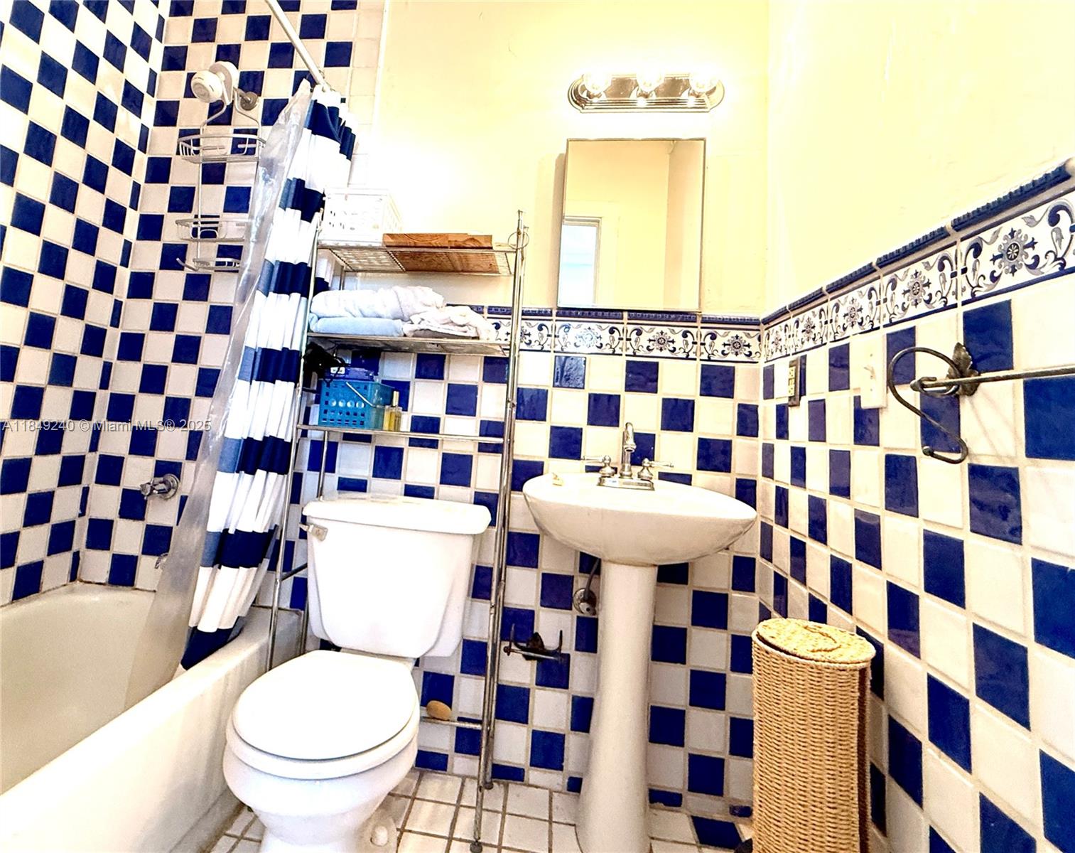 934 Michigan Avenue, Unit 304 Miami Beach, FL 33139 - Photo 6 of 30 a bathroom with a sink and a mirror