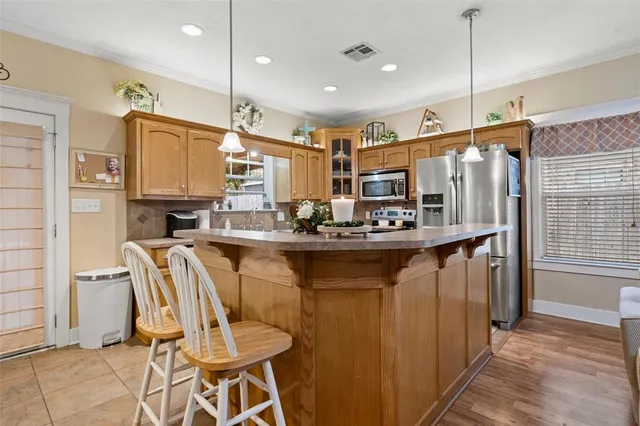a kitchen with stainless steel appliances granite countertop a sink and a refrigerator