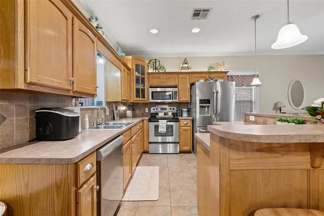 a kitchen with stainless steel appliances granite countertop a sink and cabinets