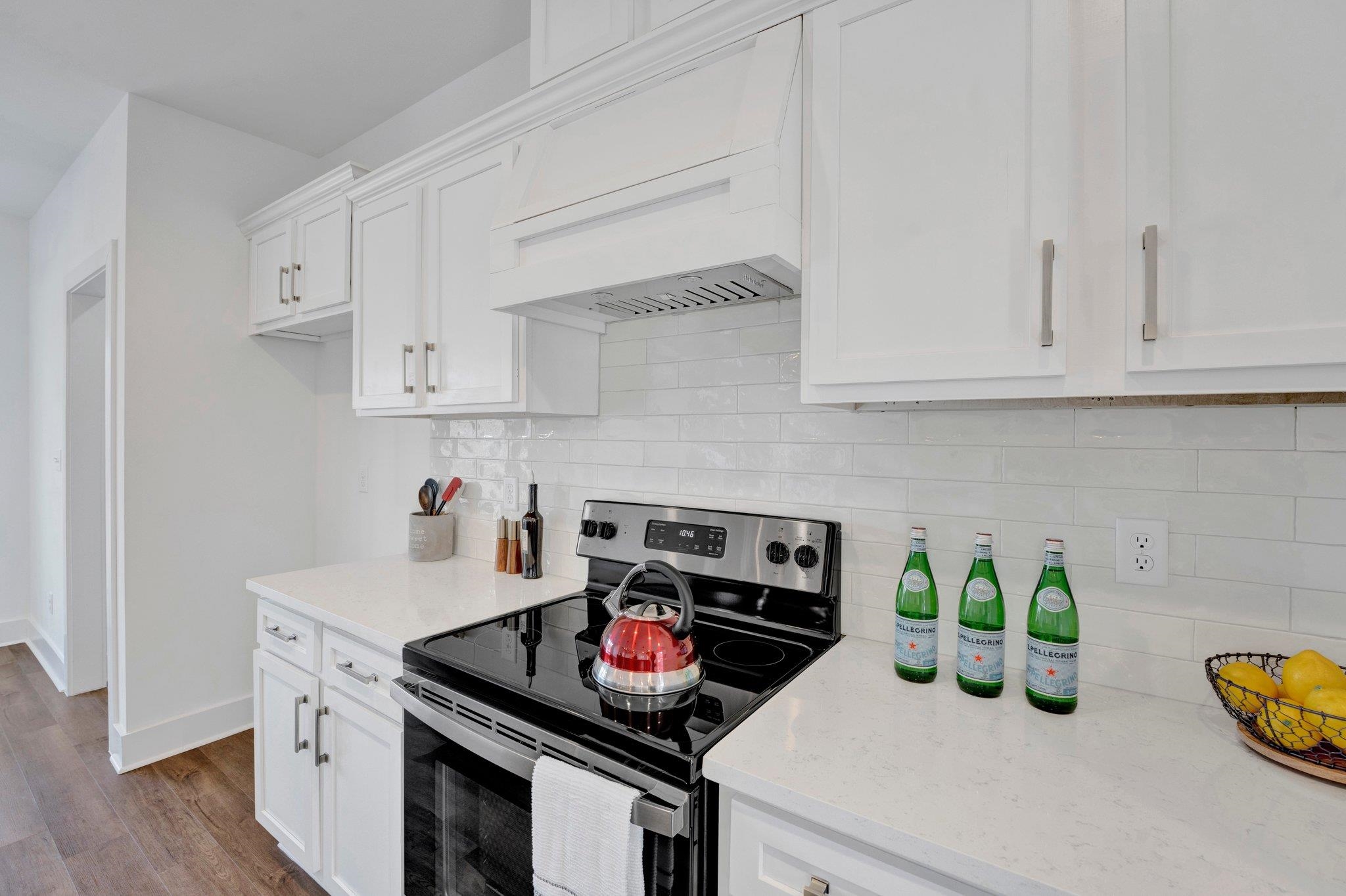 5702 Spring Lake Road Memphis, TN 38135 - Photo 11 of 38 a kitchen with white cabinets and a stove