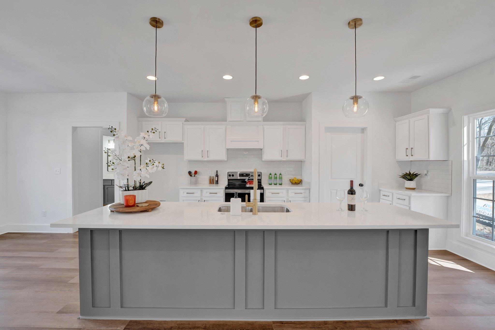 5702 Spring Lake Road Memphis, TN 38135 - Photo 13 of 38 a kitchen with white cabinets and sink