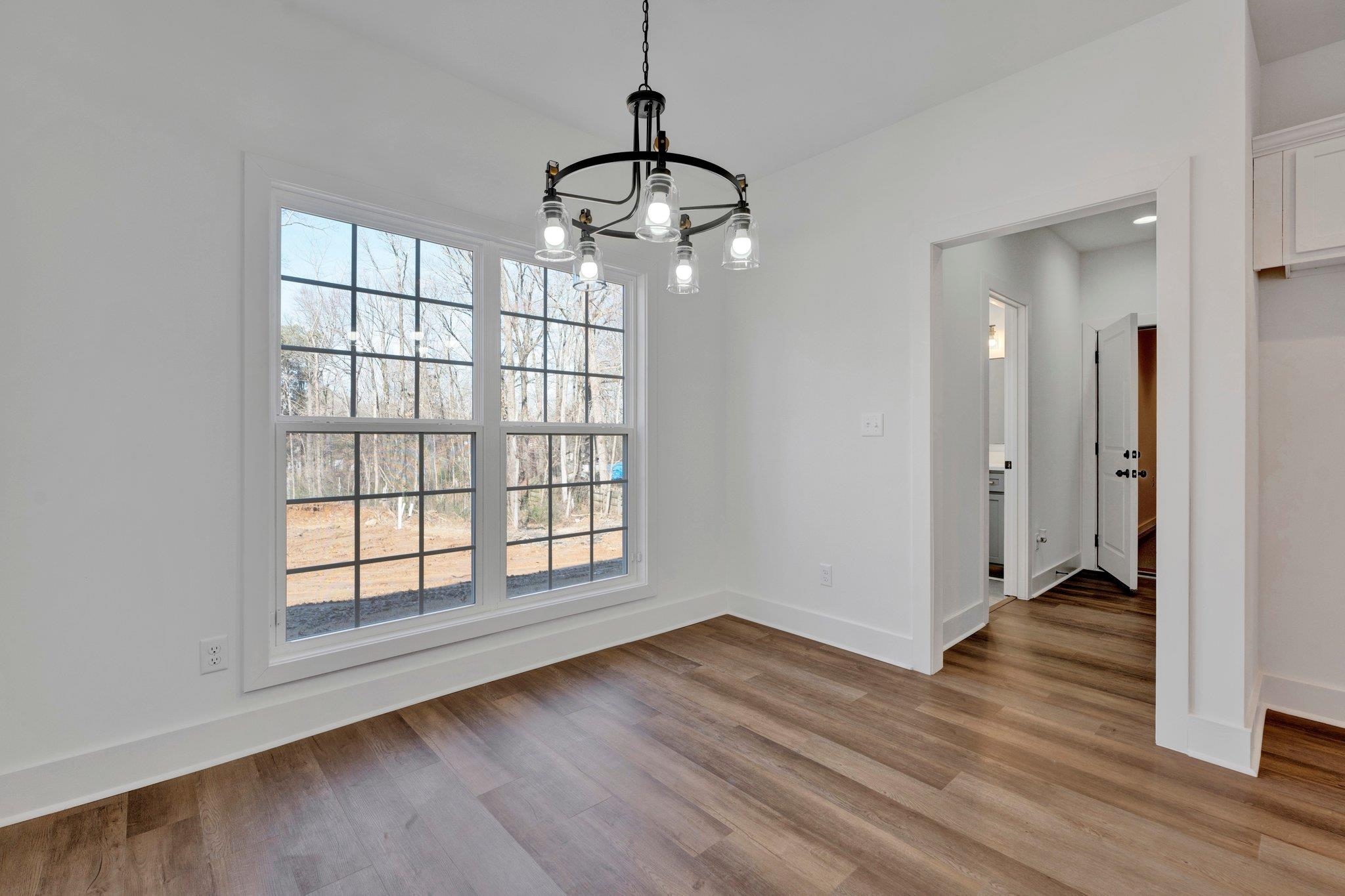 5702 Spring Lake Road Memphis, TN 38135 - Photo 17 of 38 a view of an empty room with wooden floor and a window