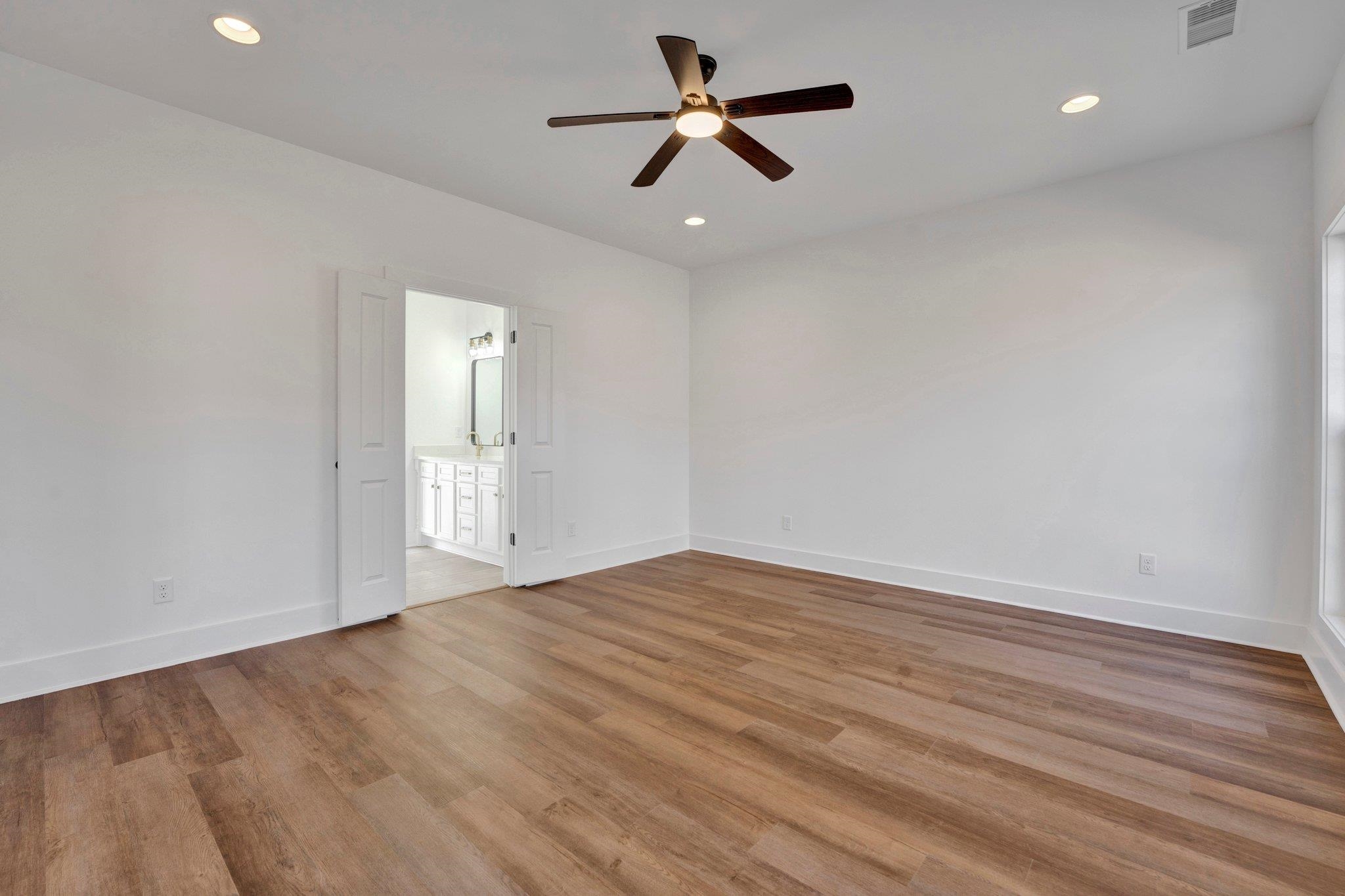 5702 Spring Lake Road Memphis, TN 38135 - Photo 19 of 38 an empty room with wooden floor and windows