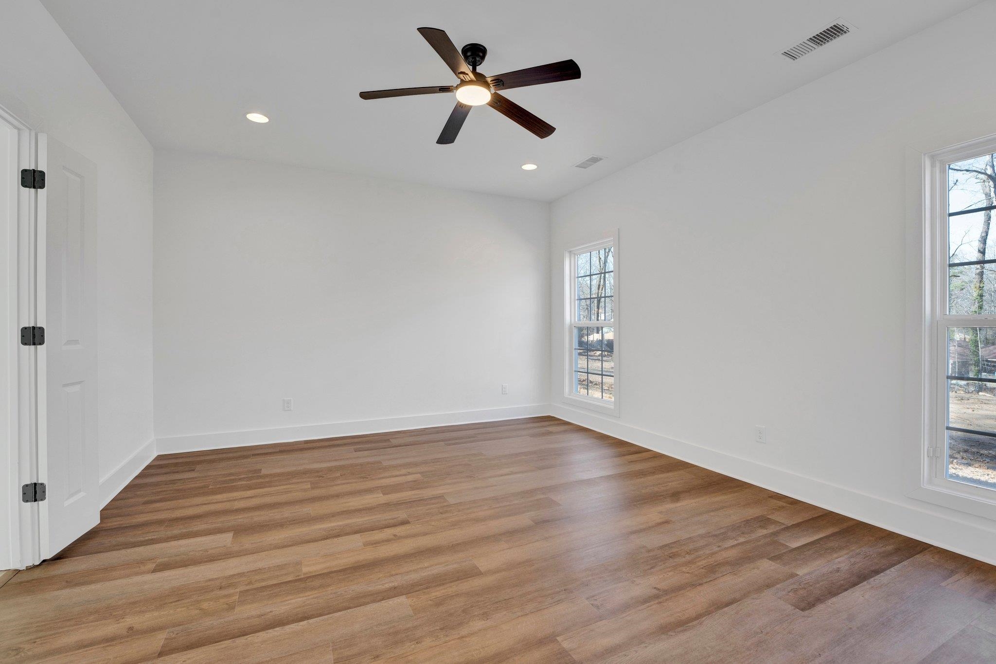 5702 Spring Lake Road Memphis, TN 38135 - Photo 20 of 38 an empty room with wooden floor and windows
