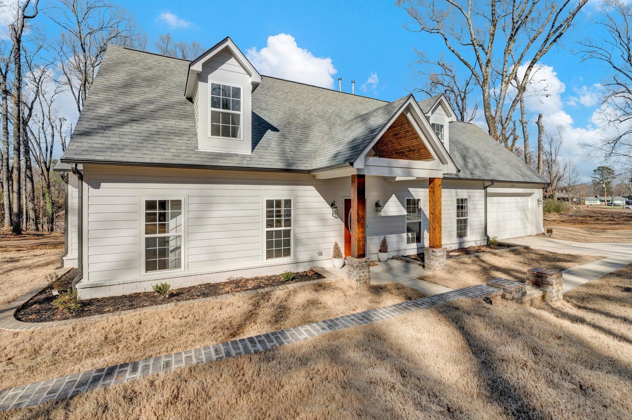 5702 Spring Lake Road Memphis, TN 38135 - Photo 2 of 38 a front view of a house with a yard and garage