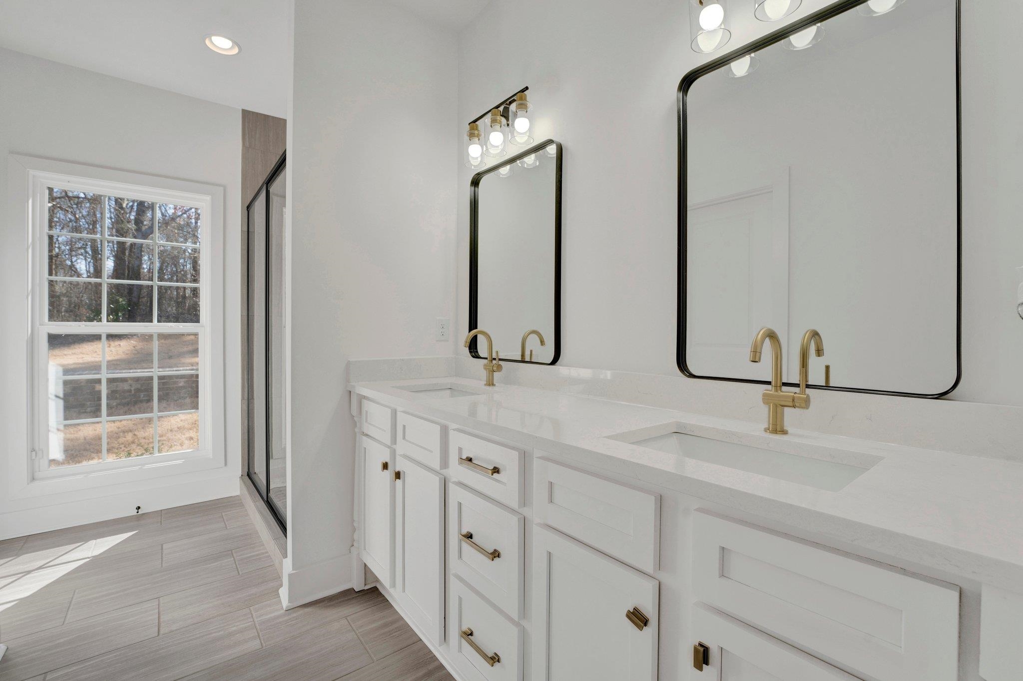 5702 Spring Lake Road Memphis, TN 38135 - Photo 21 of 38 a bathroom with double vanity sink and a mirror