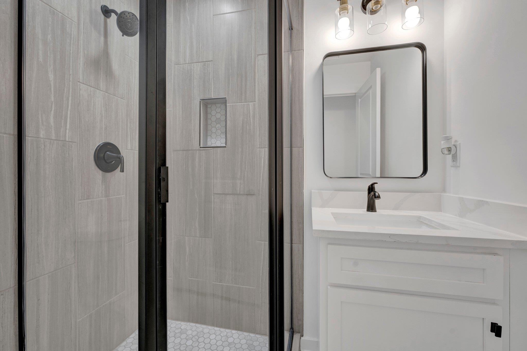 5702 Spring Lake Road Memphis, TN 38135 - Photo 26 of 38 a bathroom with a sink vanity and a mirror
