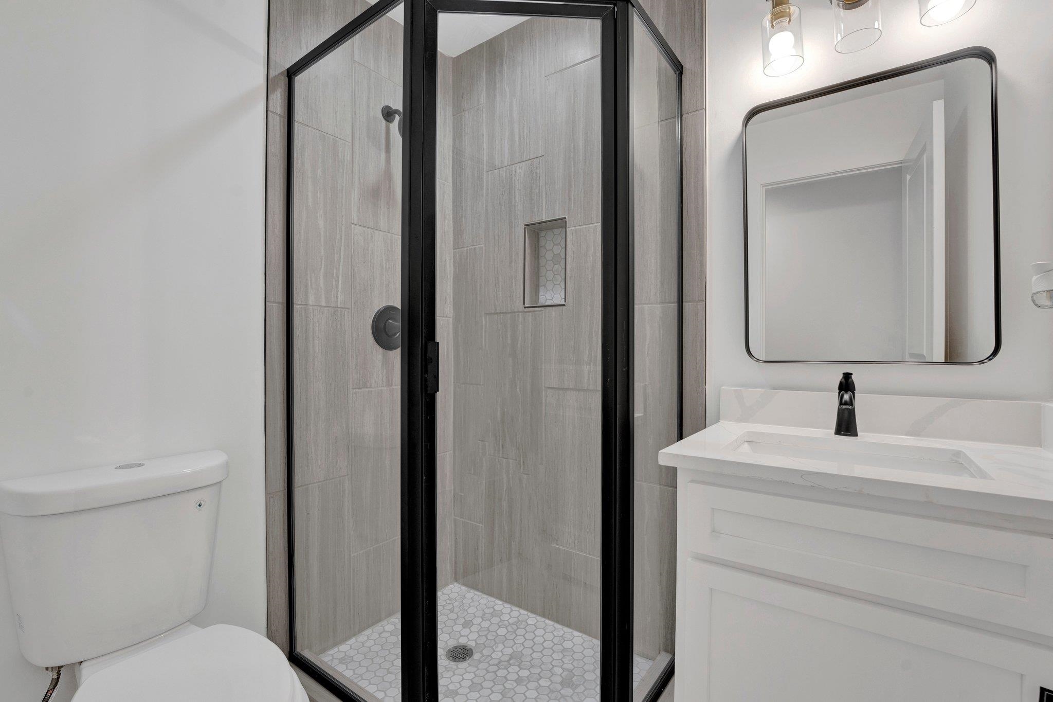 5702 Spring Lake Road Memphis, TN 38135 - Photo 27 of 38 a bathroom with a toilet sink and mirror