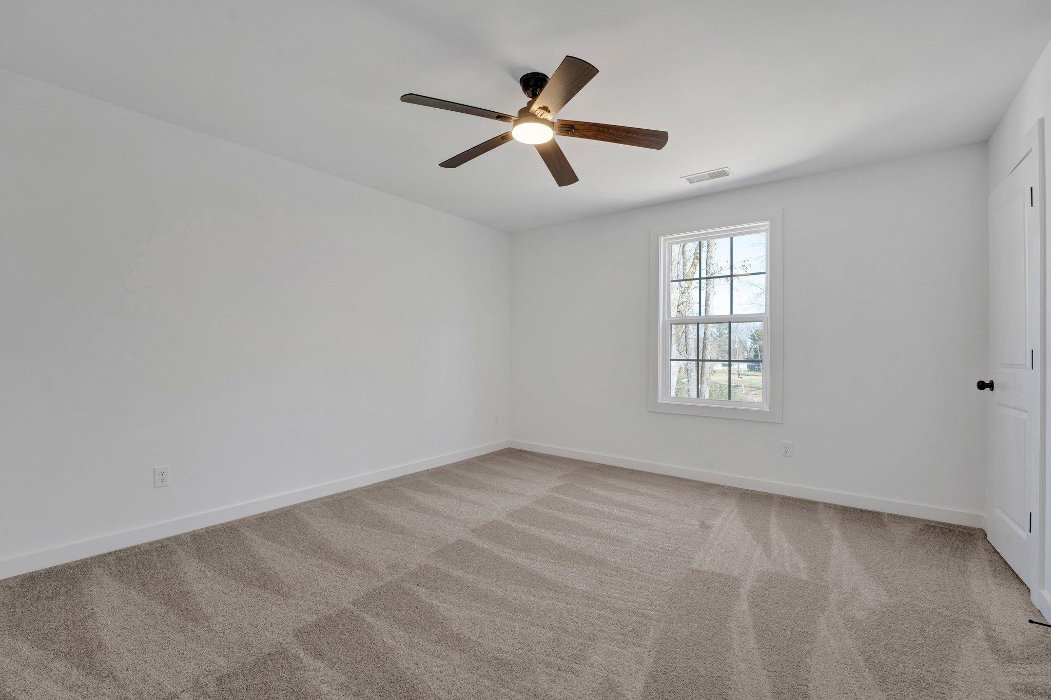 5702 Spring Lake Road Memphis, TN 38135 - Photo 32 of 38 an empty room with window and ceiling fan