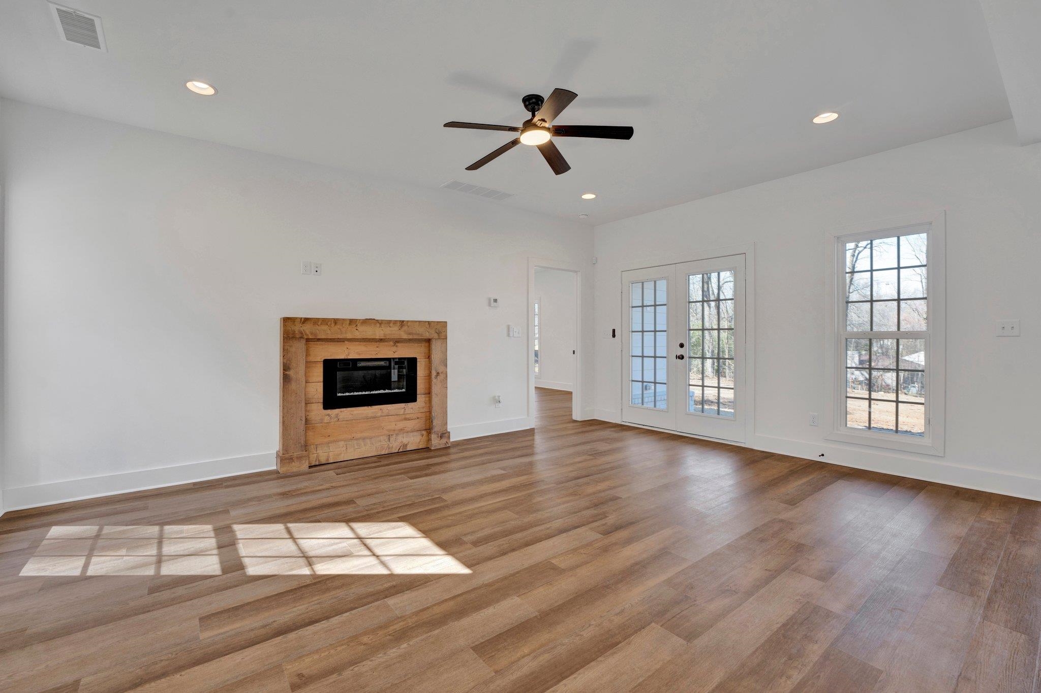 5702 Spring Lake Road Memphis, TN 38135 - Photo 7 of 38 a view of an empty room with wooden floor and a window
