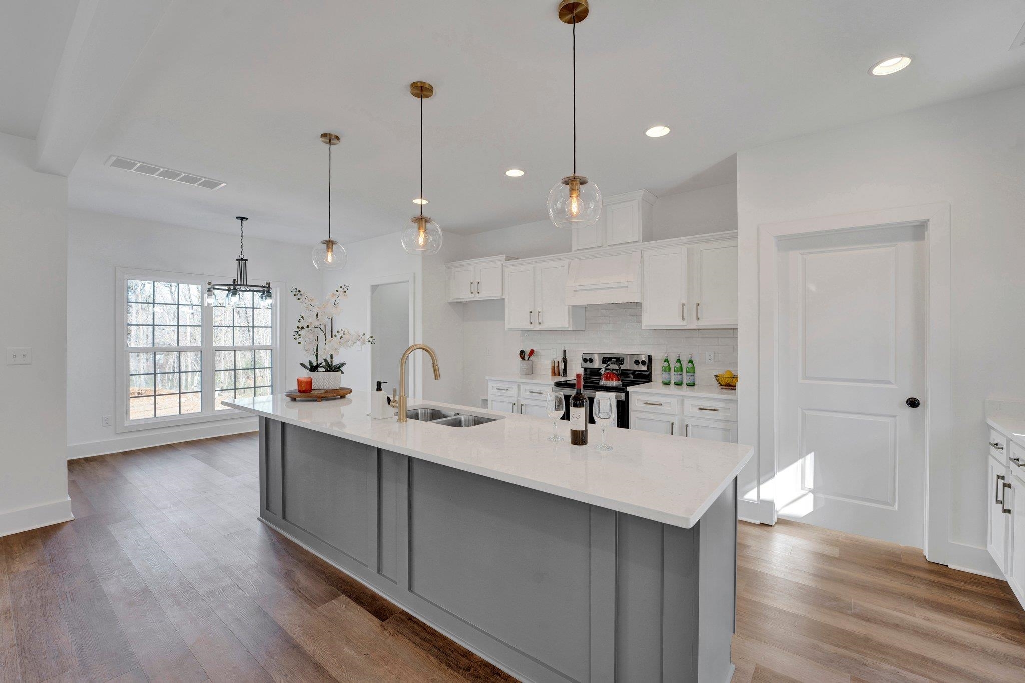 5702 Spring Lake Road Memphis, TN 38135 - Photo 8 of 38 a kitchen with kitchen island a sink stainless steel appliances and wooden floor