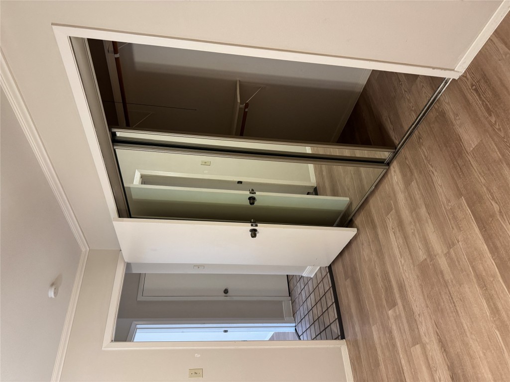 2907 Pearl Street, Unit 103 Austin, TX 78705 - Photo 11 of 20 a view of empty room with wooden floor and window