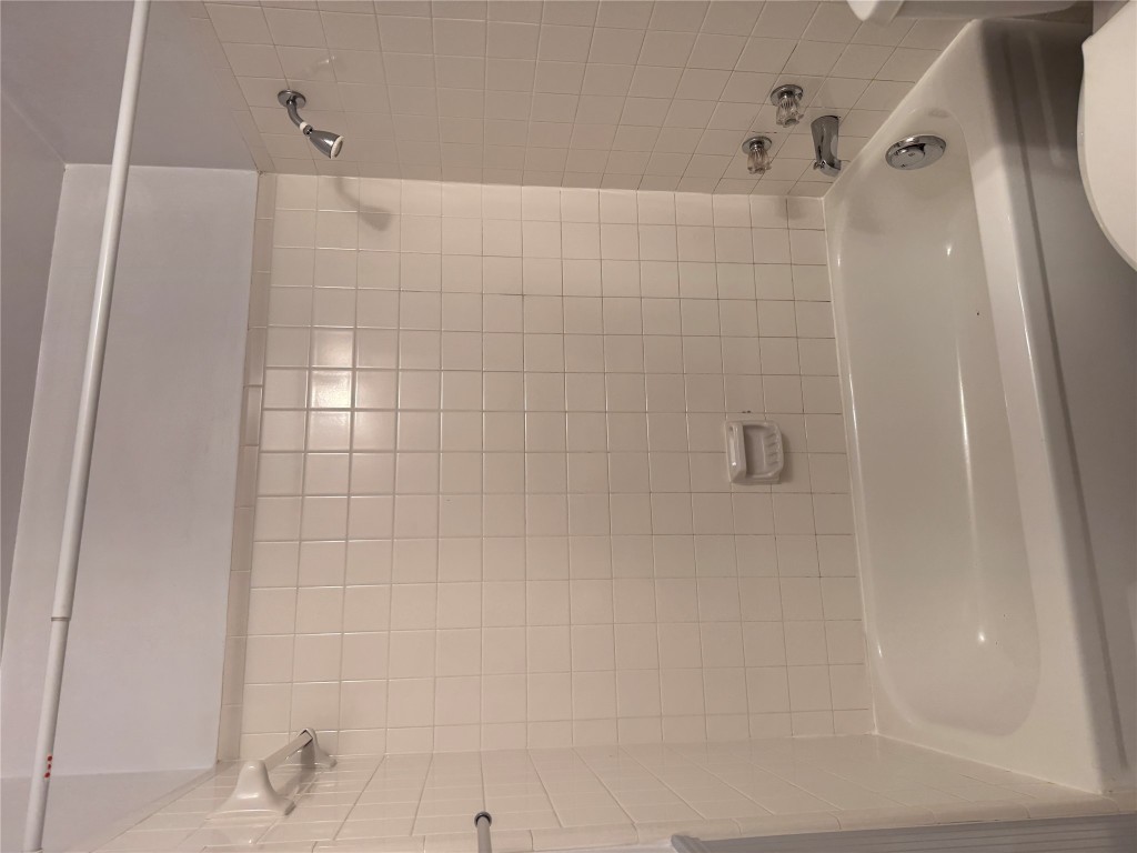 2907 Pearl Street, Unit 103 Austin, TX 78705 - Photo 12 of 20 a bathroom with a shower and a bath tub